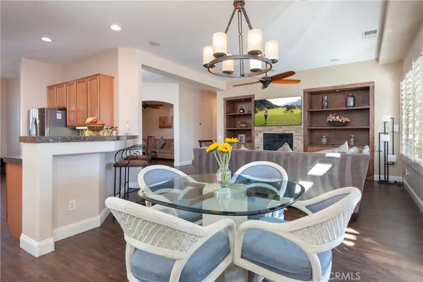 a dining room with furniture a chandelier and wooden floor