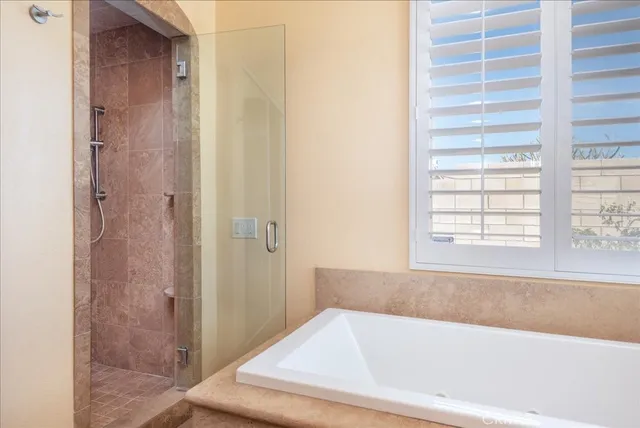 a bathroom with bathtub and window