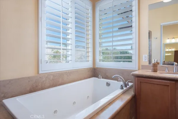 a bath tub sitting in a bathroom next to a window
