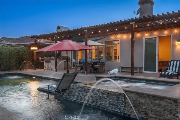 a view of a swimming pool with an outdoor seating