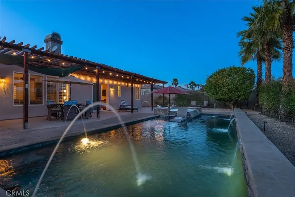 a view of a swimming pool with outdoor seating