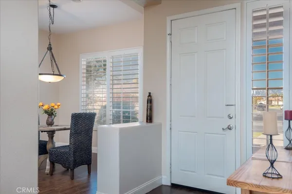 a view of a workspace with furniture and a window