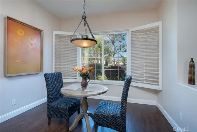 a dining room with furniture and window