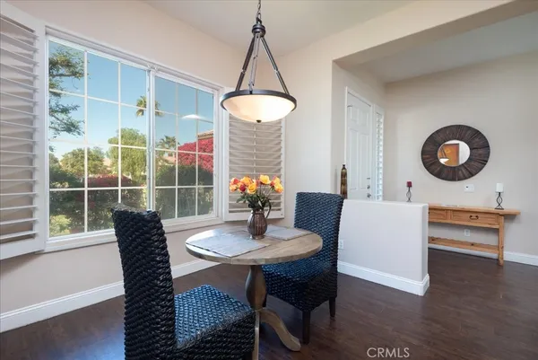 a dining room with furniture and wooden floor