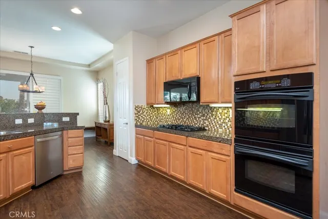 a kitchen with stainless steel appliances a stove a sink and a microwave