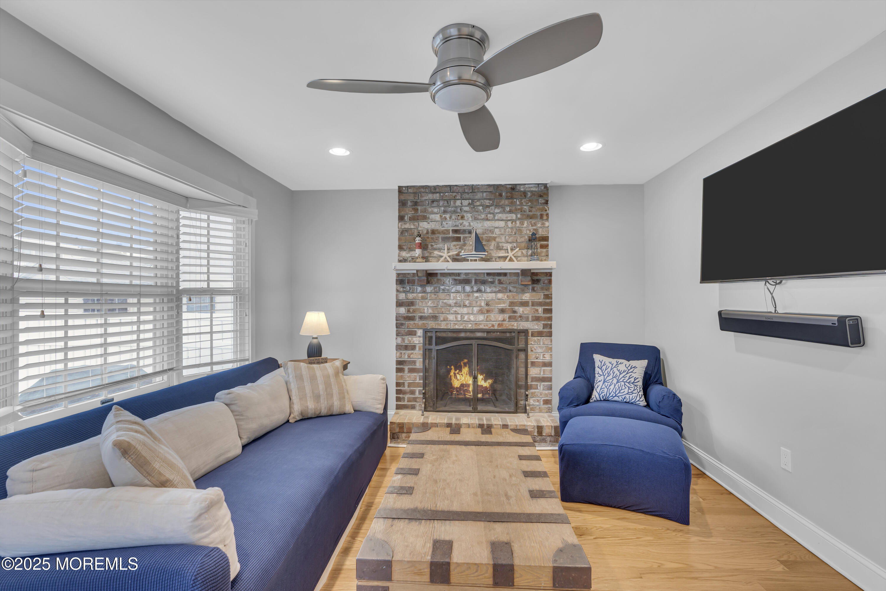 196 3rd Avenue Manasquan, NJ 08736 - Photo 12 of 36 a living room with furniture a flat screen tv and a fireplace