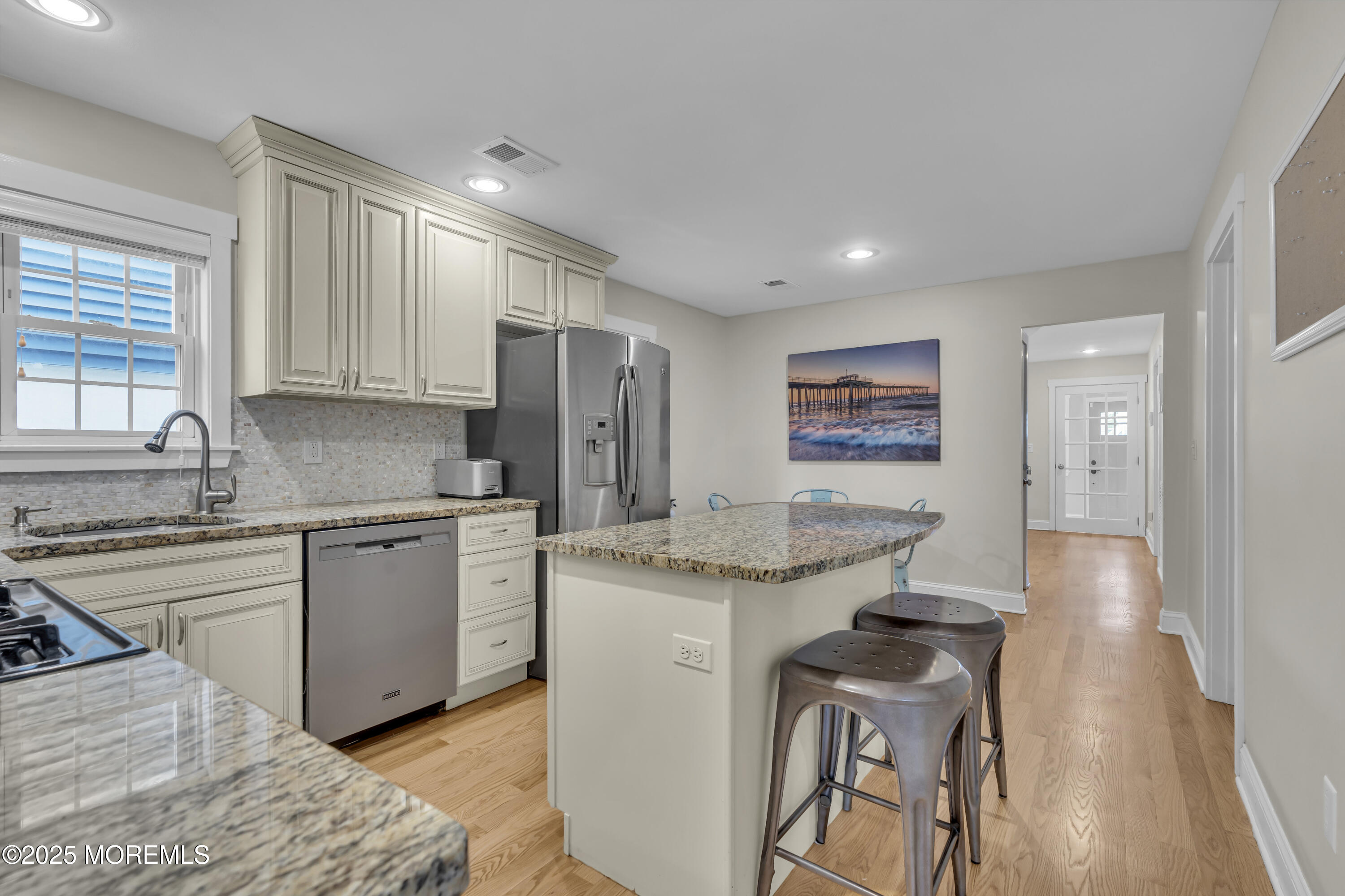 196 3rd Avenue Manasquan, NJ 08736 - Photo 10 of 36 a kitchen with granite countertop cabinets stainless steel appliances and a counter space