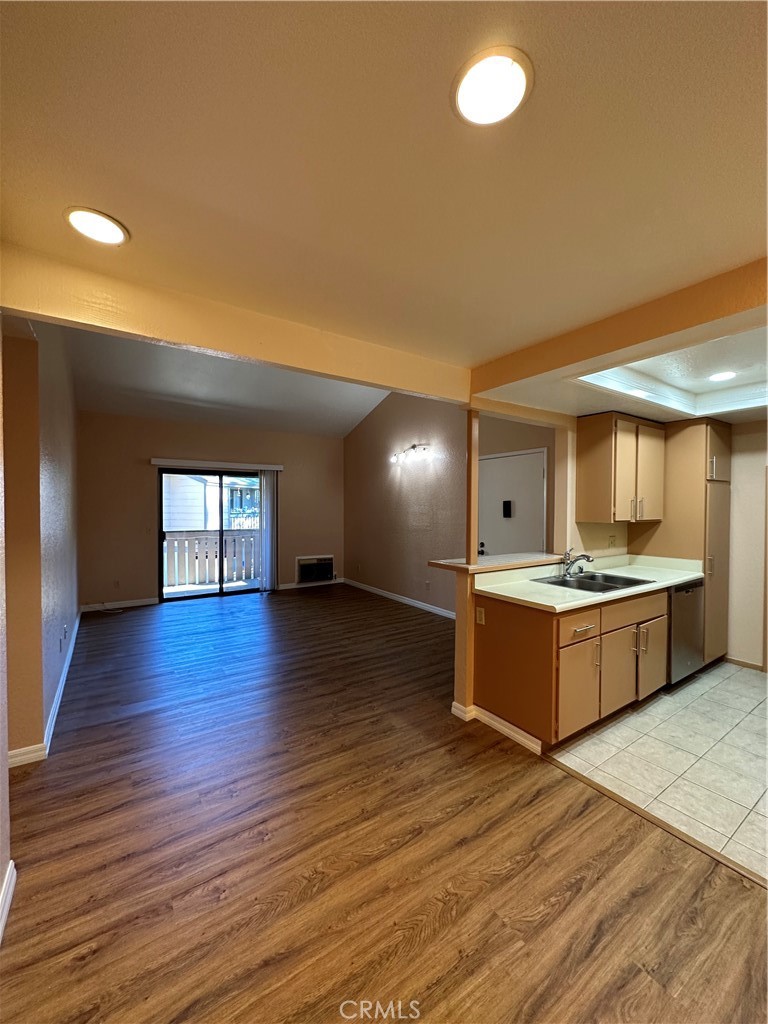 20702 El Toro Road, Unit 240 Lake Forest, CA 92630 - Photo 11 of 30 a large kitchen with wooden floors and stainless steel appliances
