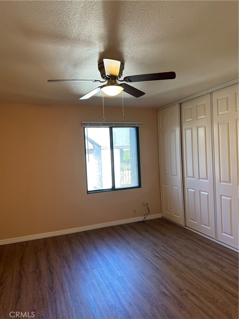 20702 El Toro Road, Unit 240 Lake Forest, CA 92630 - Photo 14 of 30 a view of an empty room with wooden floor and a window