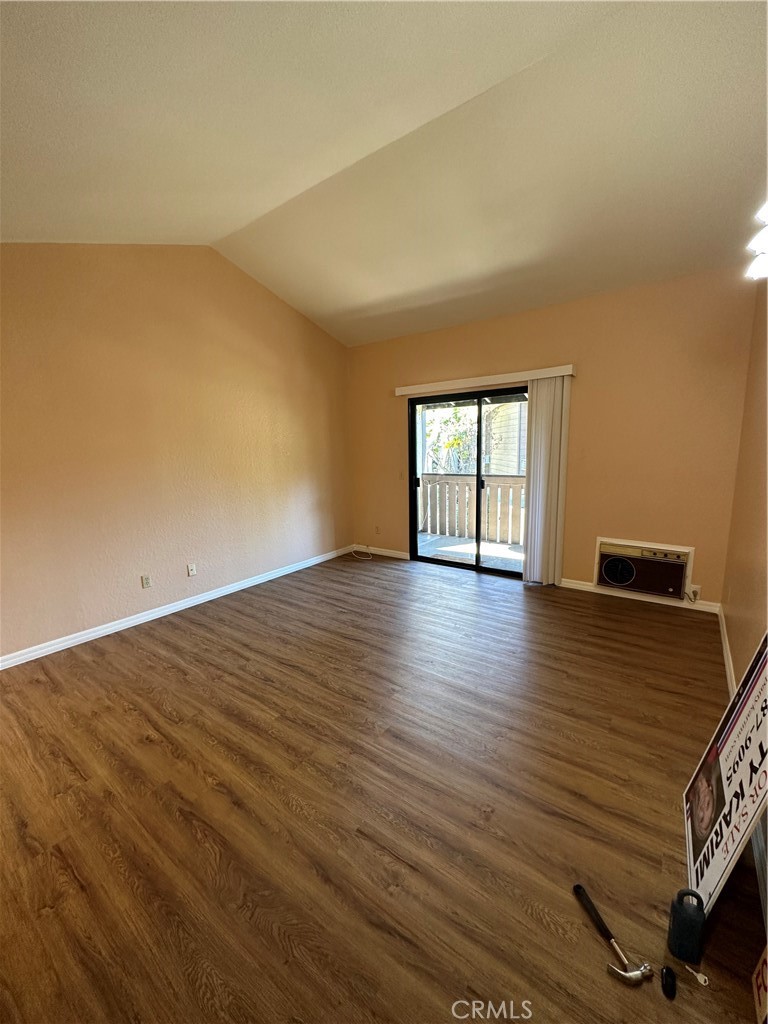 20702 El Toro Road, Unit 240 Lake Forest, CA 92630 - Photo 3 of 30 a view of an empty room with wooden floor and a window