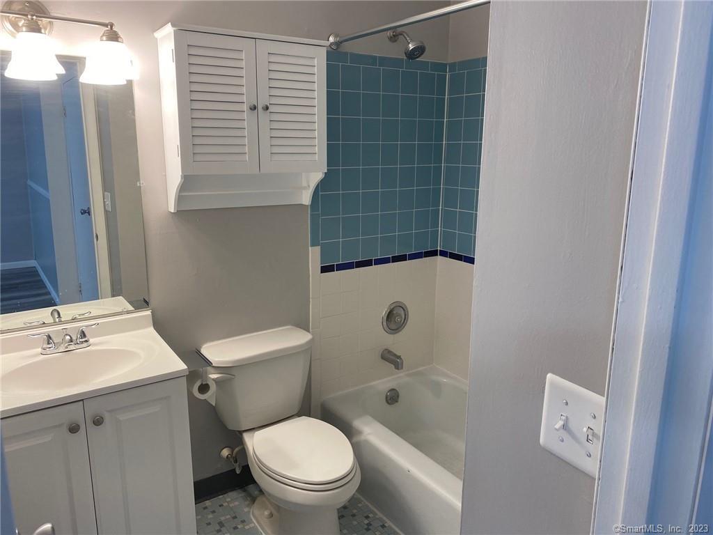 5 Village Walk, Unit 5 Wilton, CT 06897 - Photo 11 of 15 a white toilet sitting next to a bathroom sink