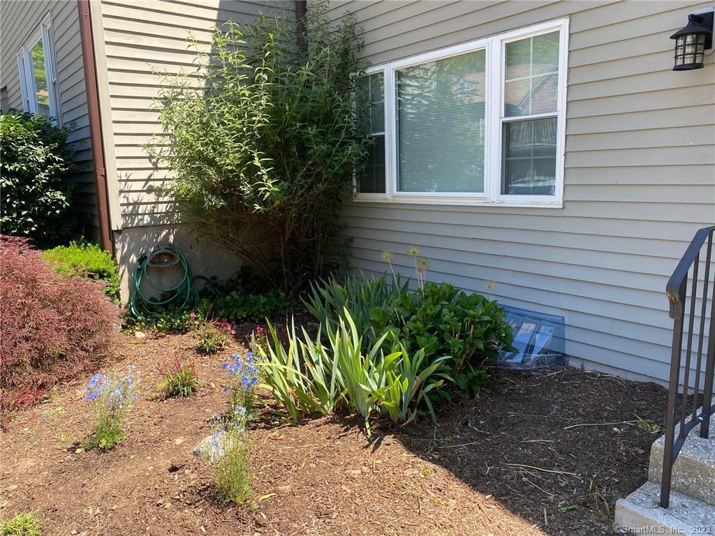 5 Village Walk, Unit 5 Wilton, CT 06897 - Photo 15 of 15 a view of a backyard with plants