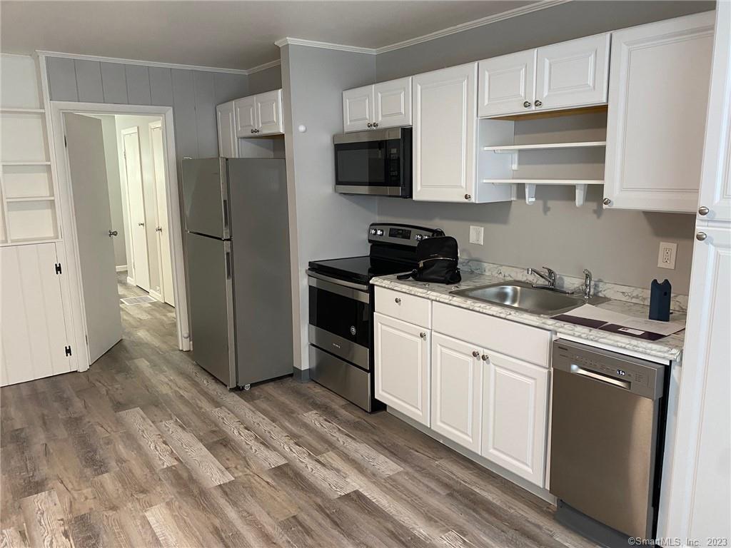 5 Village Walk, Unit 5 Wilton, CT 06897 - Photo 5 of 15 a kitchen with a refrigerator stove and sink