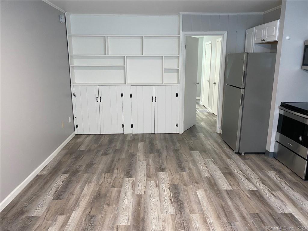 5 Village Walk, Unit 5 Wilton, CT 06897 - Photo 6 of 15 a view of empty room with wooden floor and electronic appliances