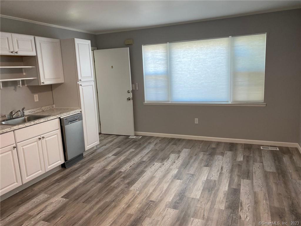 5 Village Walk, Unit 5 Wilton, CT 06897 - Photo 7 of 15 a view of a kitchen with wooden floor and electronic appliances
