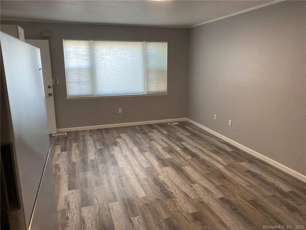 5 Village Walk, Unit 5 Wilton, CT 06897 - Photo 8 of 15 wooden floor and window in a room
