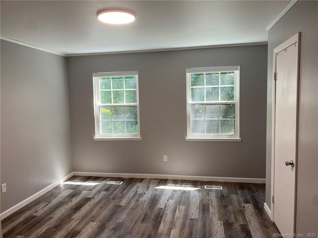 5 Village Walk, Unit 5 Wilton, CT 06897 - Photo 9 of 15 a view of an empty room with wooden floor and a window