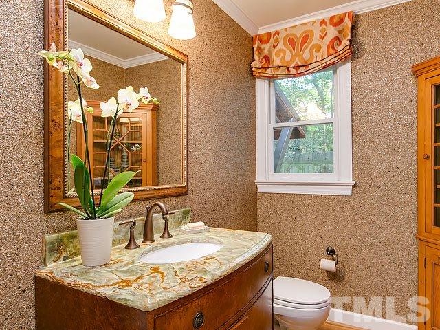 2004 Buckingham Road Raleigh, NC 27607 - Photo 14 of 25 a bathroom with a granite countertop sink a toilet and a mirror