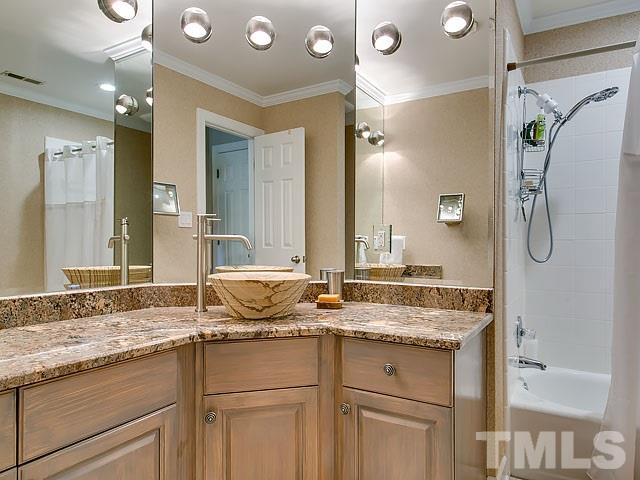 2004 Buckingham Road Raleigh, NC 27607 - Photo 20 of 25 a bathroom with a granite countertop double vanity sink mirror and double