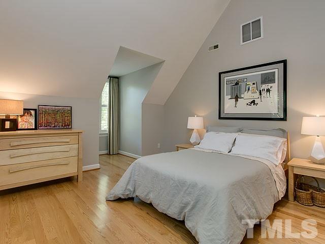 2004 Buckingham Road Raleigh, NC 27607 - Photo 22 of 25 a bedroom with a bed and a painting on the wall