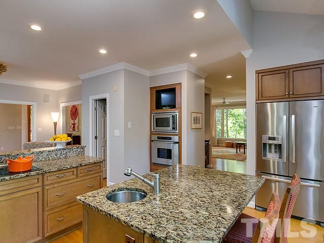 2004 Buckingham Road Raleigh, NC 27607 - Photo 5 of 25 a kitchen with stainless steel appliances granite countertop sink refrigerator and stove