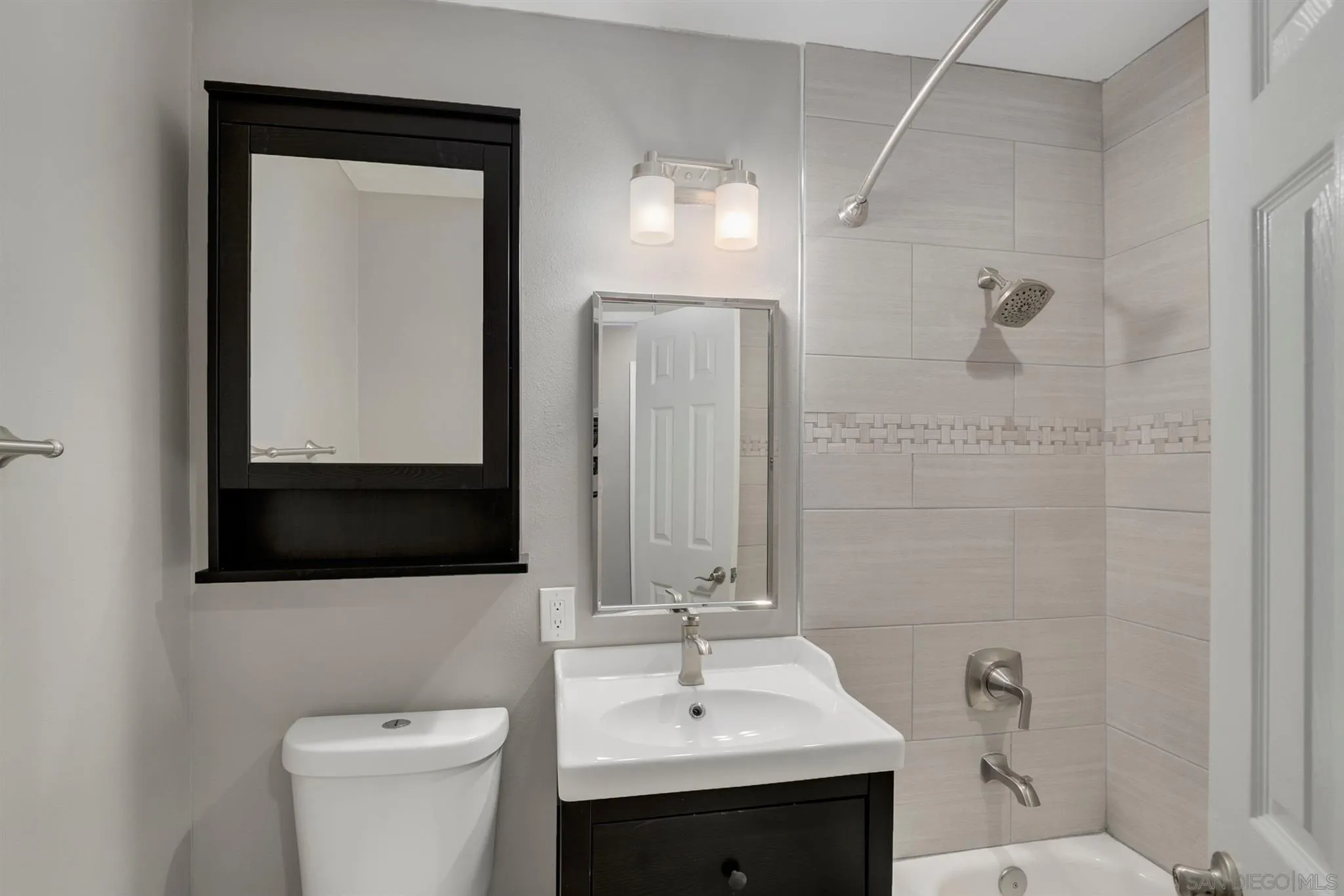 9753 Settle Road Santee, CA 92071 - Photo 12 of 31 a bathroom with a sink a toilet and mirror