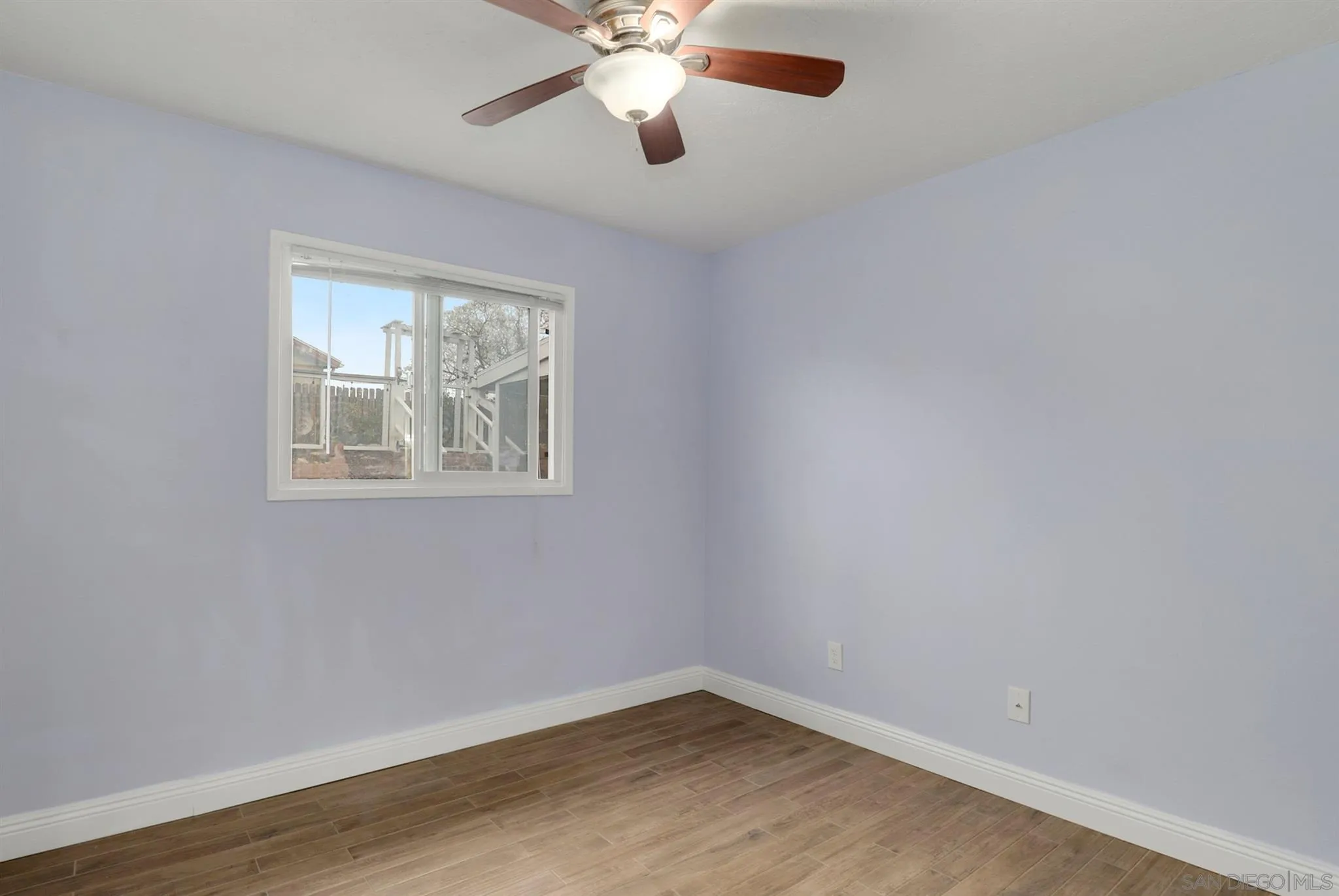9753 Settle Road Santee, CA 92071 - Photo 14 of 31 a view of an empty room with wooden floor and a window