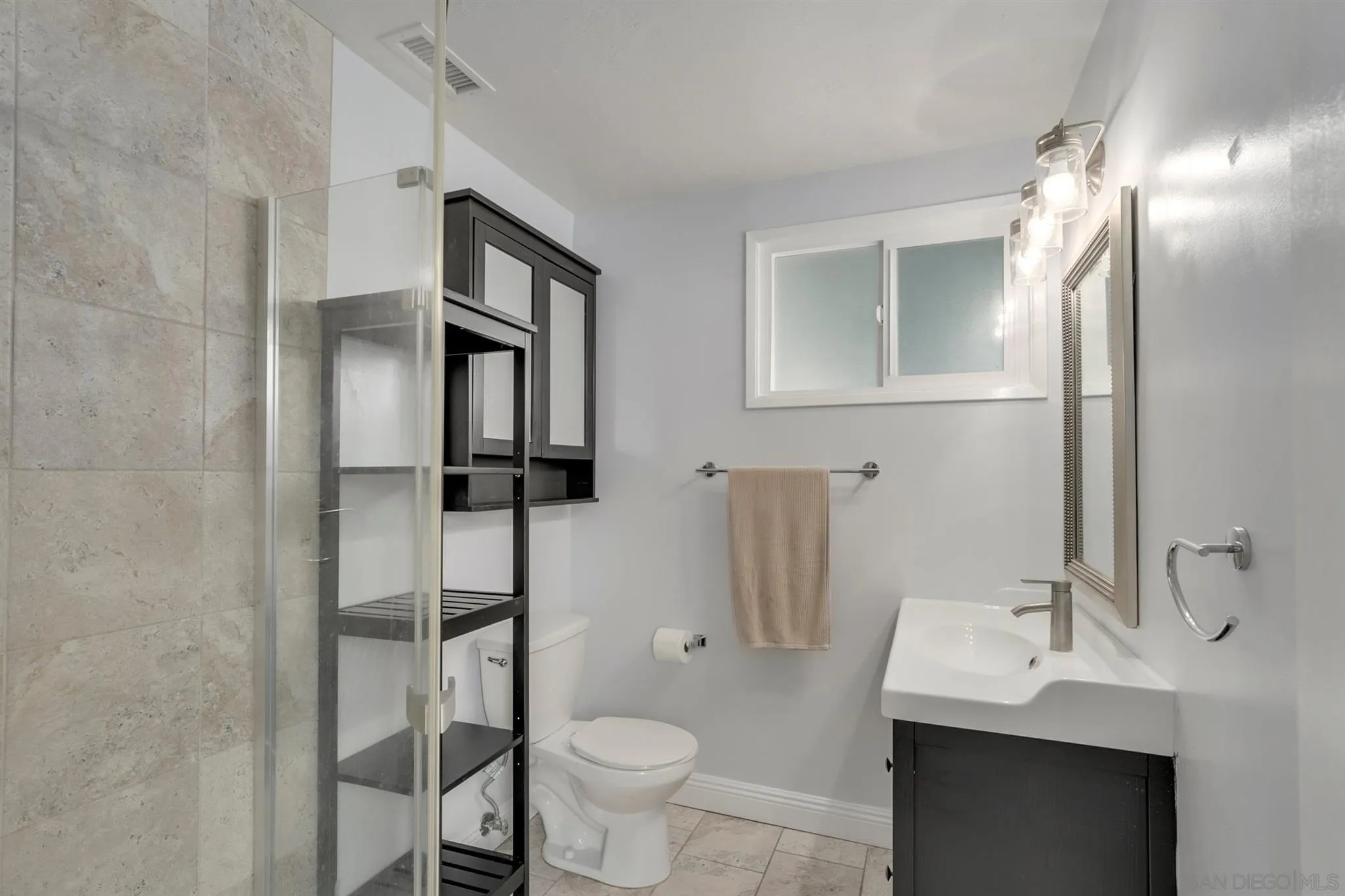 9753 Settle Road Santee, CA 92071 - Photo 18 of 31 a bathroom with a sink toilet and shower