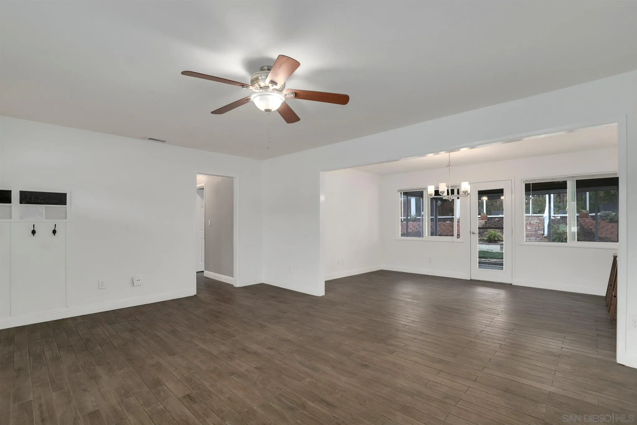 9753 Settle Road Santee, CA 92071 - Photo 9 of 31 a view of an empty room with wooden floor and a window