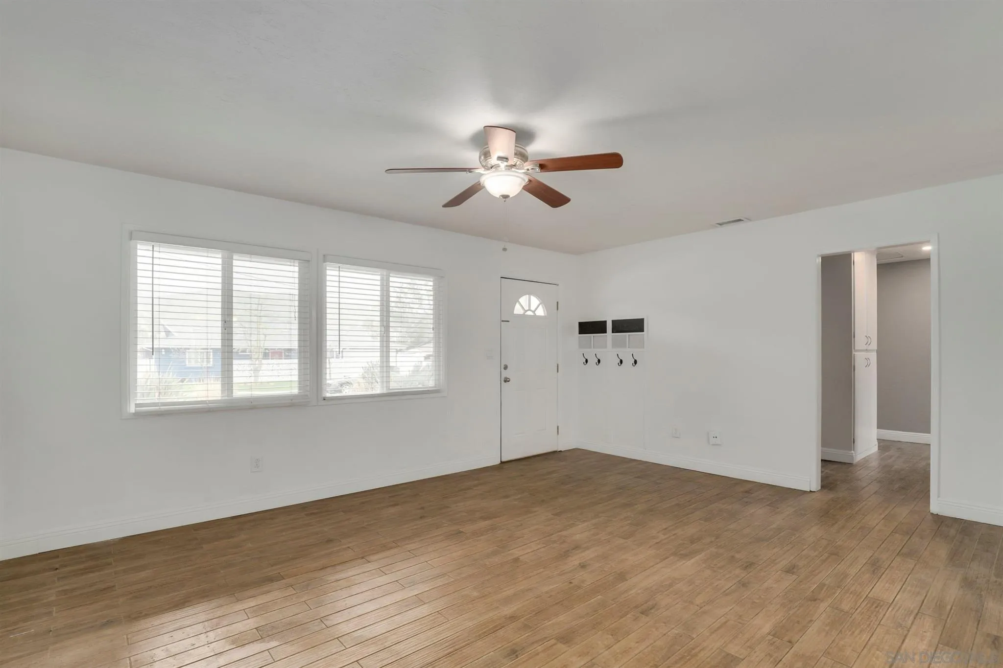 9753 Settle Road Santee, CA 92071 - Photo 10 of 31 a view of a room with a ceiling fan and hardwood floor