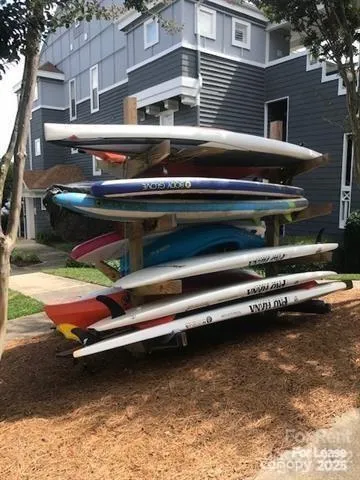 a roof deck with a table and a barbeque