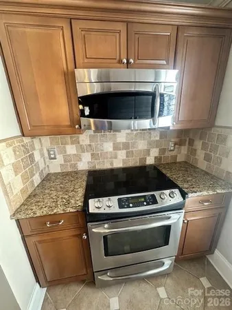 a stove top oven sitting inside of a kitchen