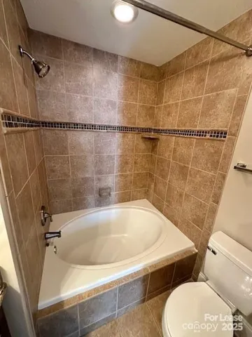 a bath tub sitting next to a white toilet