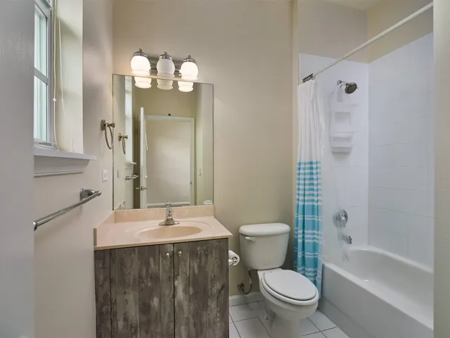 a bathroom with a sink a toilet a mirror and shower