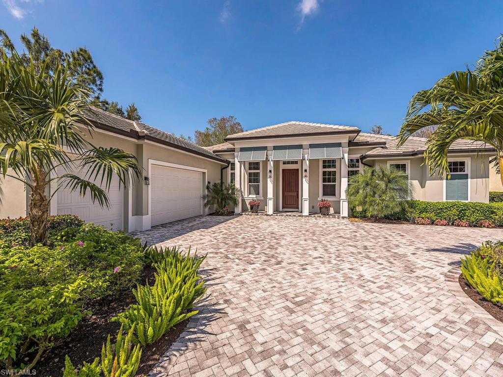 2305 Harrier Run Naples, FL 34105 - Photo 1 of 15 a front view of a house with a garden