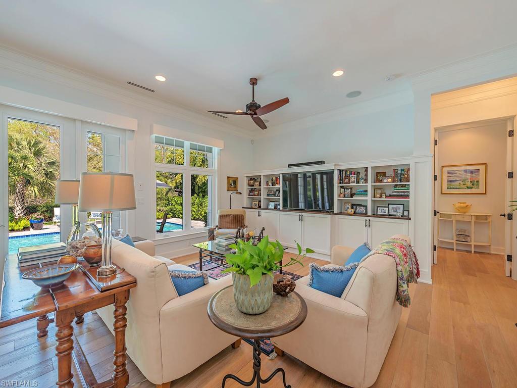 2305 Harrier Run Naples, FL 34105 - Photo 3 of 15 a living room with furniture potted plant and a large window