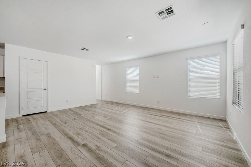 773 Fallen Phoenix Street Henderson, NV 89011 - Photo 13 of 28 Empty room with baseboards and light wood-style floors