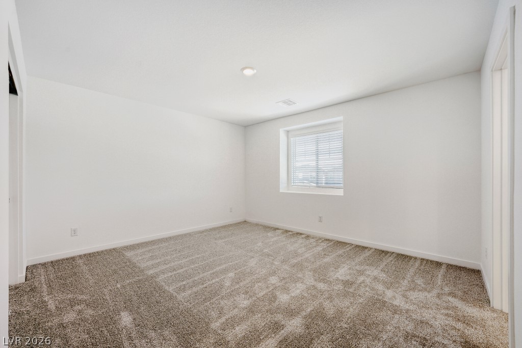 773 Fallen Phoenix Street Henderson, NV 89011 - Photo 15 of 28 Spare room with light carpet and baseboards