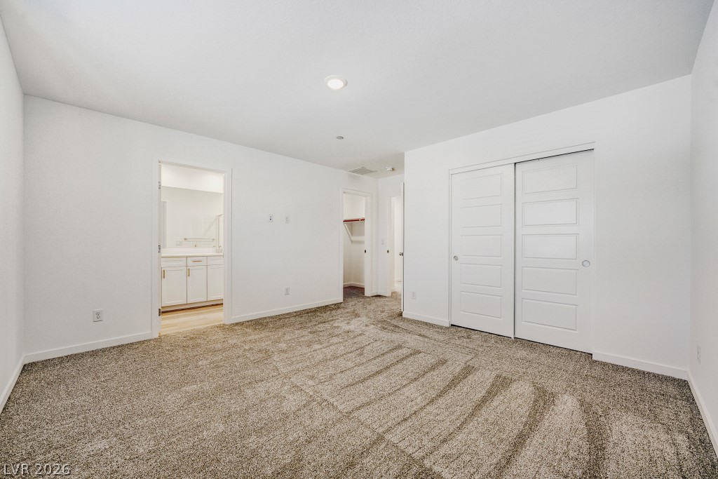 773 Fallen Phoenix Street Henderson, NV 89011 - Photo 16 of 28 Unfurnished bedroom with a closet, light colored carpet, and ensuite bathroom