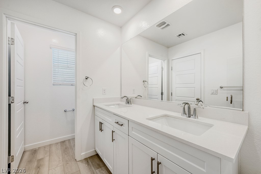 773 Fallen Phoenix Street Henderson, NV 89011 - Photo 18 of 28 Full bath featuring double vanity and light wood-type flooring