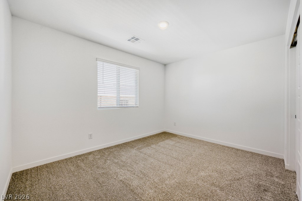 773 Fallen Phoenix Street Henderson, NV 89011 - Photo 20 of 28 Empty room featuring light carpet and baseboards