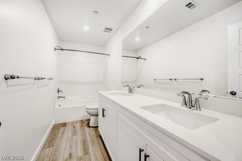 773 Fallen Phoenix Street Henderson, NV 89011 - Photo 22 of 28 Full bathroom featuring double vanity, light wood-type flooring, and bathing tub / shower combination