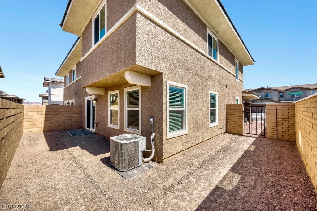 773 Fallen Phoenix Street Henderson, NV 89011 - Photo 27 of 28 Rear view of house with a fenced backyard, a gate, and stucco siding