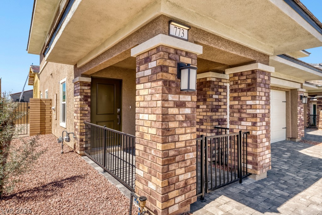 773 Fallen Phoenix Street Henderson, NV 89011 - Photo 4 of 28 View of exterior entry with a gate and brick siding