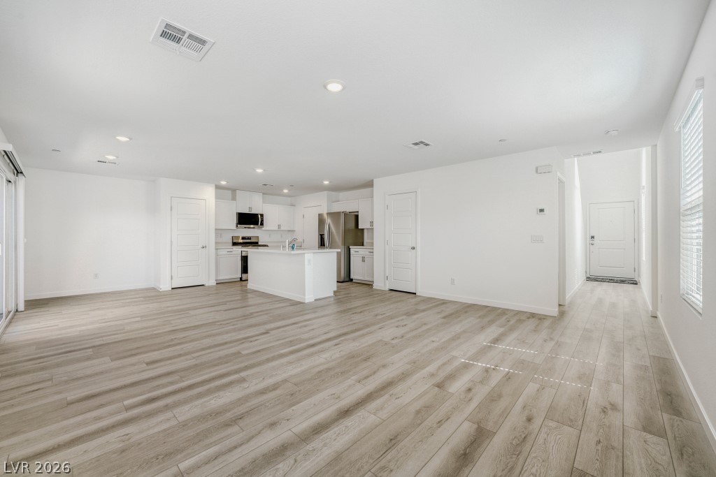 773 Fallen Phoenix Street Henderson, NV 89011 - Photo 7 of 28 Unfurnished living room featuring light wood-style floors and recessed lighting