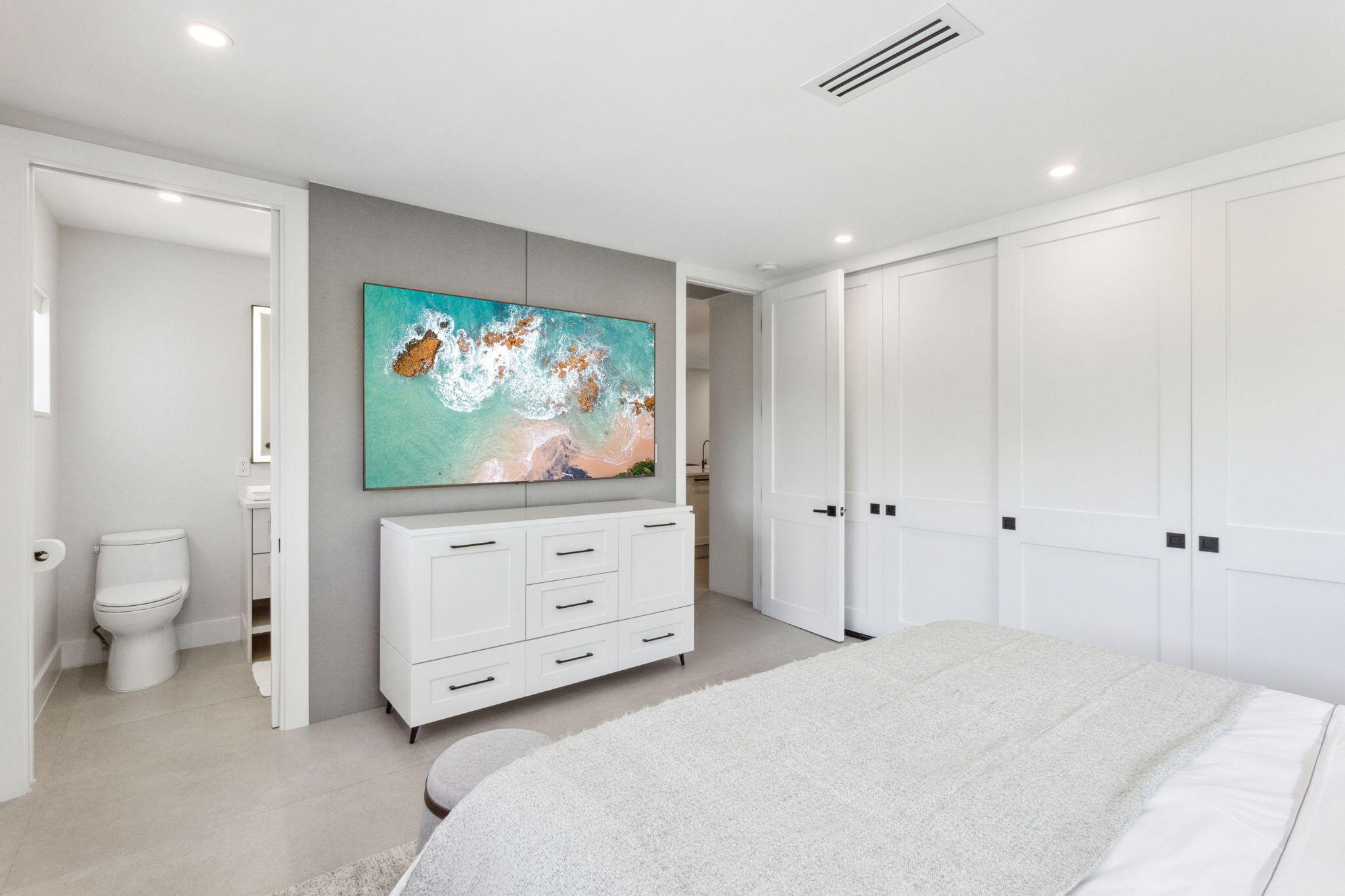 3401 South Ocean Boulevard, Unit 6 Highland Beach, FL 33487 - Photo 14 of 33 a spacious bedroom with a bed and a flat screen tv