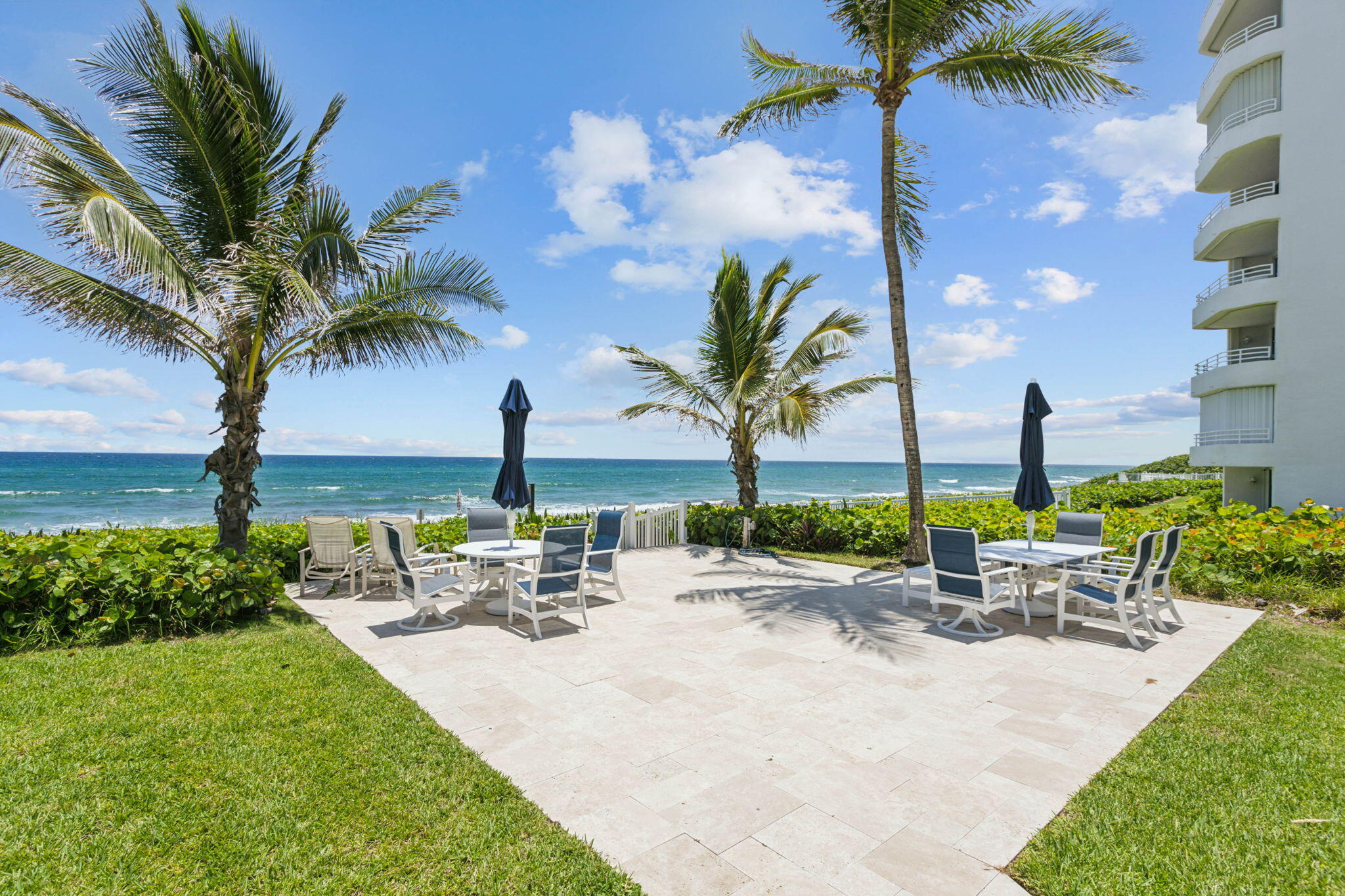 3401 South Ocean Boulevard, Unit 6 Highland Beach, FL 33487 - Photo 21 of 33 a view of a swimming pool with a table and chairs