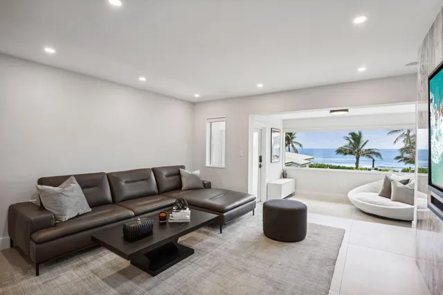 a bedroom with a large bed and a potted plant