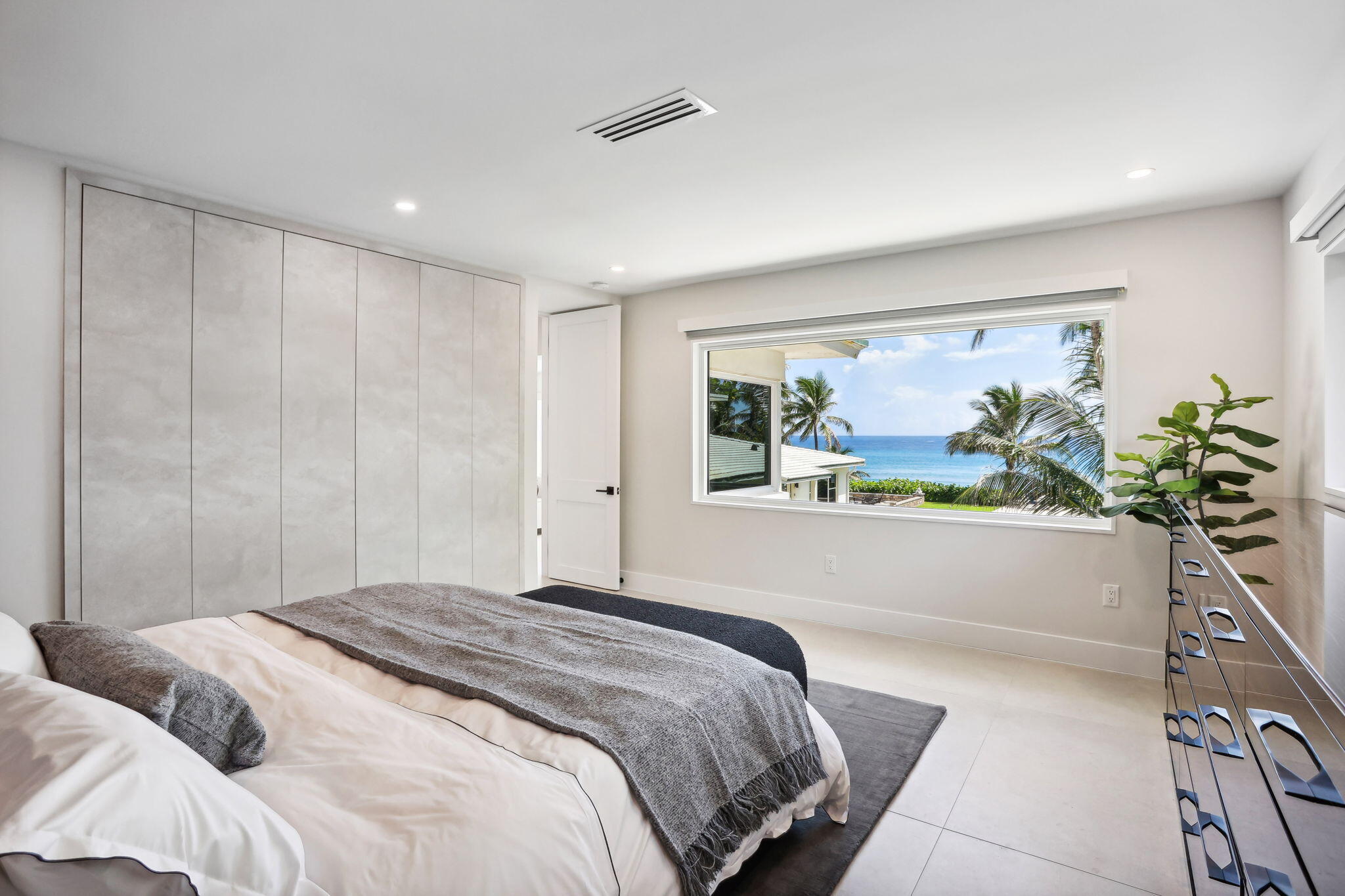 3401 South Ocean Boulevard, Unit 6 Highland Beach, FL 33487 - Photo 4 of 33 a bedroom with a large bed and a potted plant