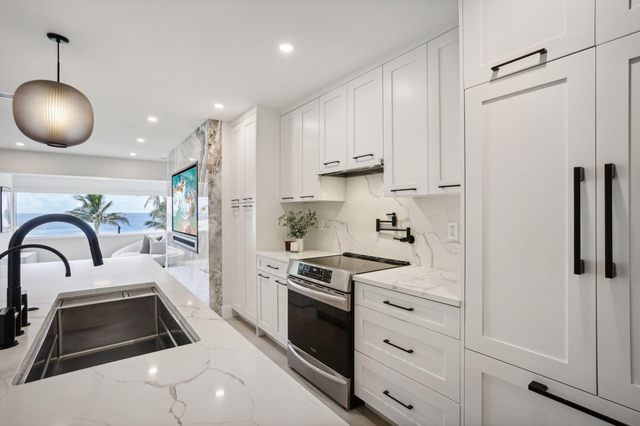 3401 South Ocean Boulevard, Unit 6 Highland Beach, FL 33487 - Photo 10 of 33 a kitchen with white cabinets and stainless steel appliances